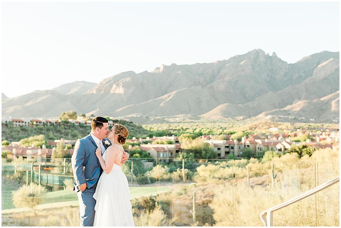 Bride and Groom standing on the balcony at Hacienda Del Sol in front of the Catalina mountains