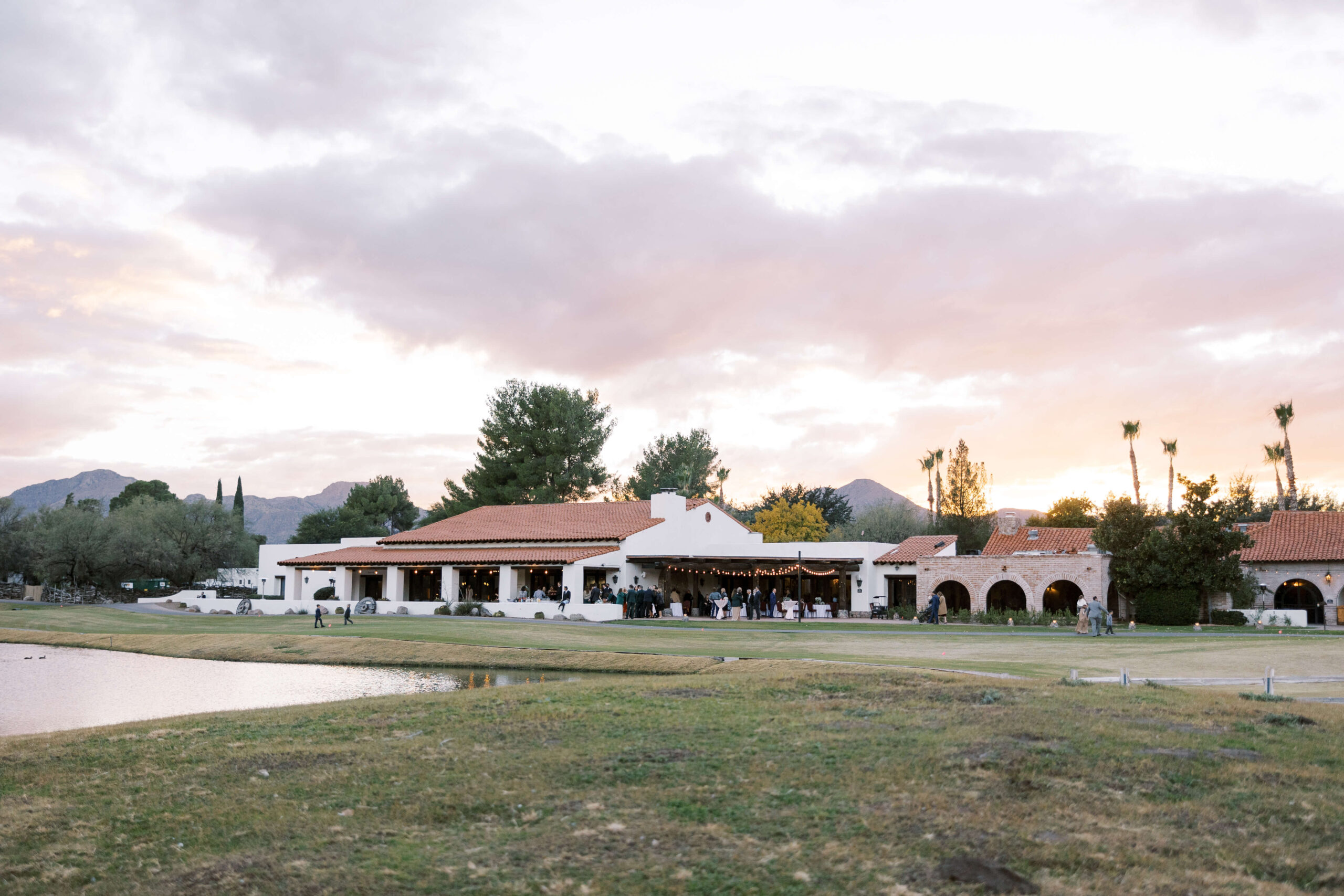 Views of the Geronimo Ballroom at Tubac Golf Resort from outside with a cotton candy sunset behind